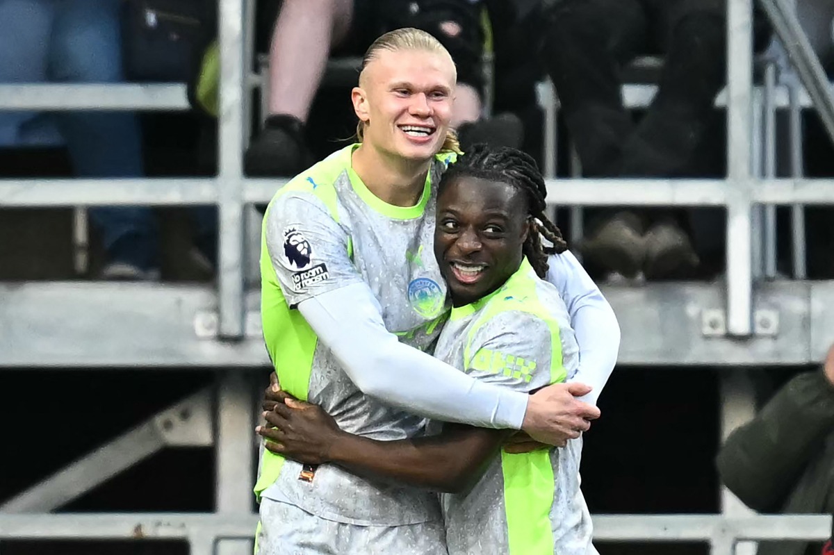 Manchester City's Norwegian striker #09 Erling Haaland (L) celebrates scoring the team's first goal during the English Premier League football match between Burnley and Manchester City at Turf Moor in Burnley, north-west England on April 22, 2026. (Photo by Paul ELLIS / AFP)