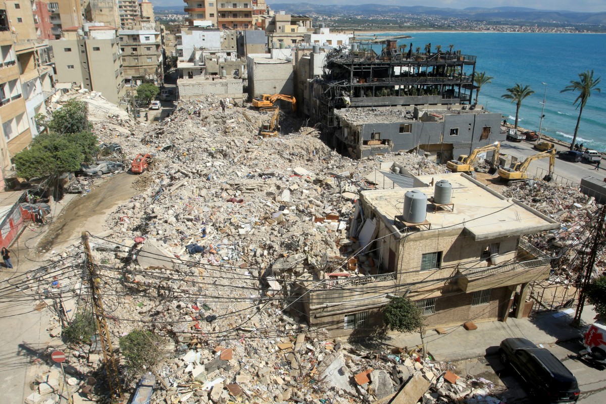 Diggers remove the rubble of buildings destroyed in Israeli strikes as they look for survivors buried underneath in the southern Lebanese coastal city of Tyre on April 21, 2026. Photo by Mahmoud Zayyat / AFP