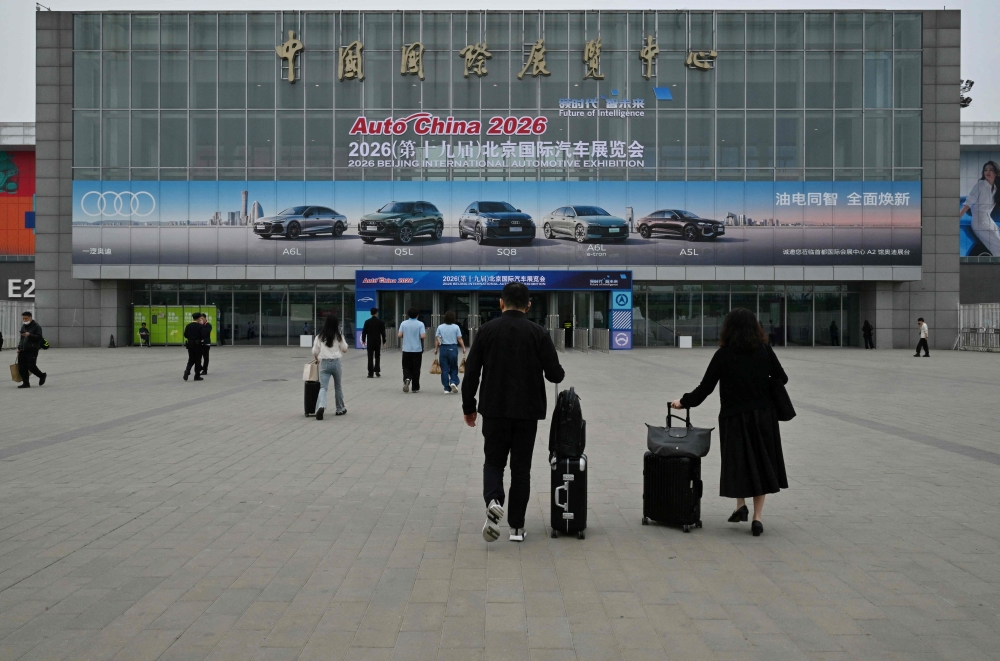 People visit the Beijing Auto Show on its opening day in Beijing on April 24, 2026. (Photo by Adek Berry / AFP)
