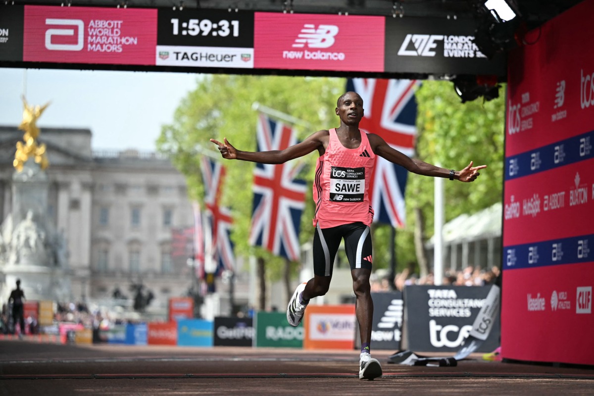 Kenya's Sabastian Sawe crosses the line to win the men's race in a new world record time at the 2026 London Marathon in central London on April 26, 2026. Photo by JUSTIN TALLIS / AFP