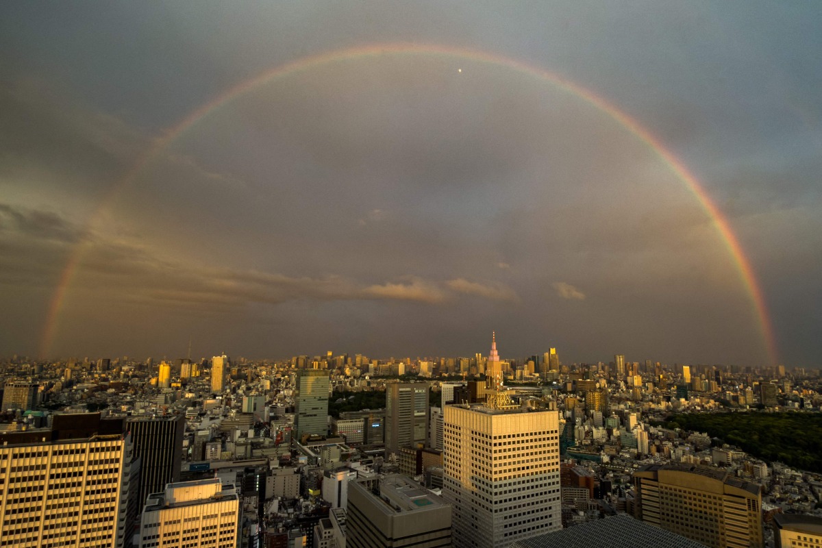 A general view shows the city skyline and a rainbow from the Tokyo Metropolitan Government Building observation deck in the Shinjuku district of central Tokyo on April 27, 2026. (Photo by Philip FONG / AFP)