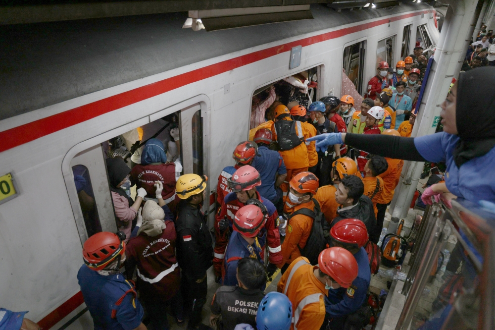 Rescuers work at the train accident site in Bekasi, Indonesia. A commuter train on the Jakarta-Bekasi route was involved in a collision with a long-distance train operating on the Jakarta-Surabaya route at around 8:50pm local time on Monday. (Photo by B. Nugraha/Xinhua)