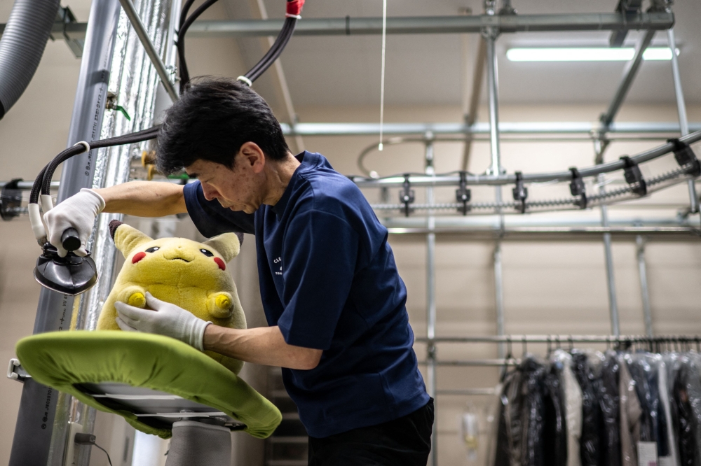 JAPAN-CULTURE-TOYS-INTERNET
In this picture taken on April 27, 2026, dry-cleaning professional Masakazu Shimura steam-cleans a soft toy at the facility of Cleaning Yonmarusan in Fuefuki city of Yamanashi Prefecture.  

(Photo by Philip FONG / AFP)
