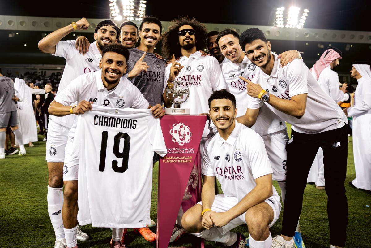 Al Sadd players celebrate their QSL title on Monday.