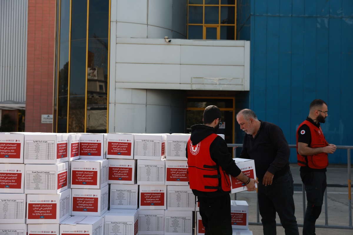 QRCS representatives distributing emergency relief aid to displaced and war-affected families in Beirut.