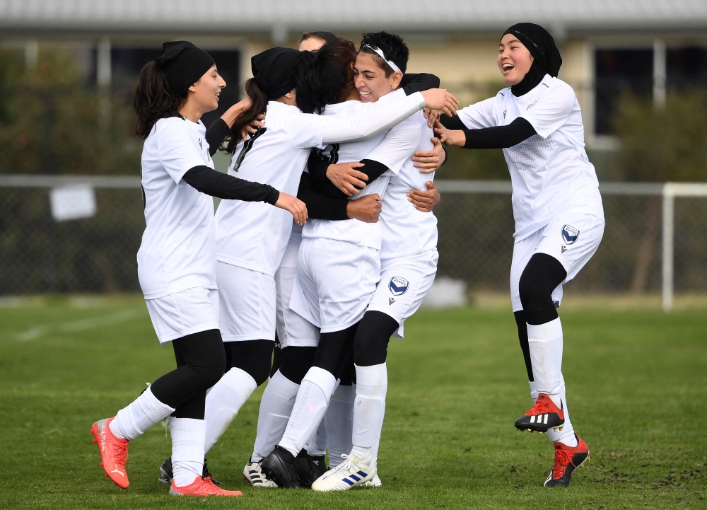 AFGHANISTAN-WOMEN-FIFA
Members of the Afghanistan's national women's football team playing under the Melbourne Victory Afghan women. (Photo by William WEST / AFP)  