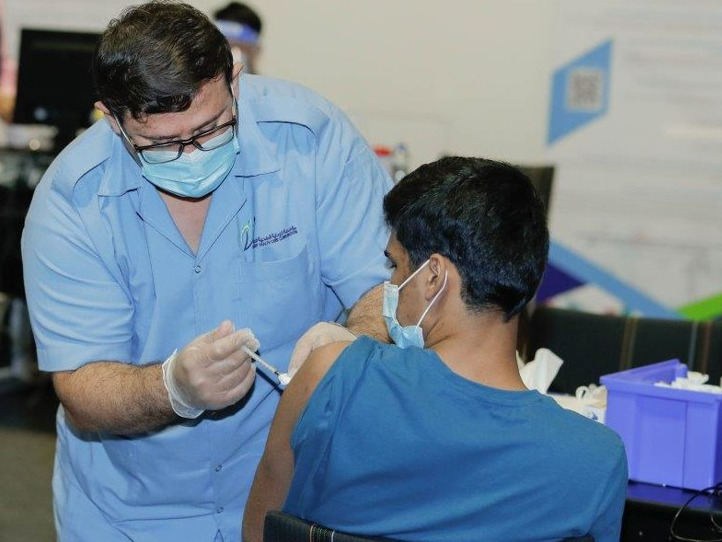 A PHCC nurse administering vaccine for a patient