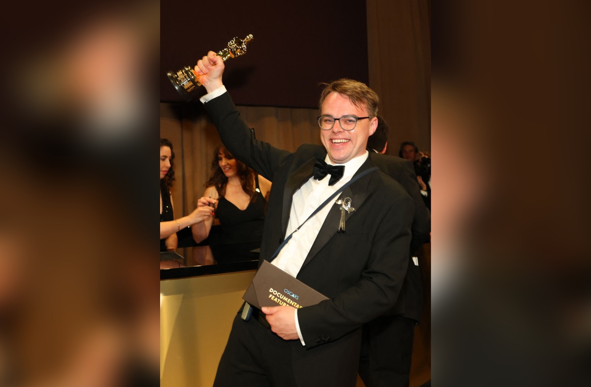 Russian teacher Pavel Talankin hoists his Oscar for Best Documentary Feature Film for 