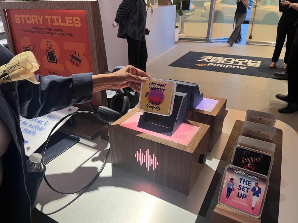 A customer shops at the Audible Story House in New York, on April 30, 2026. The pop-up store labeled as a 