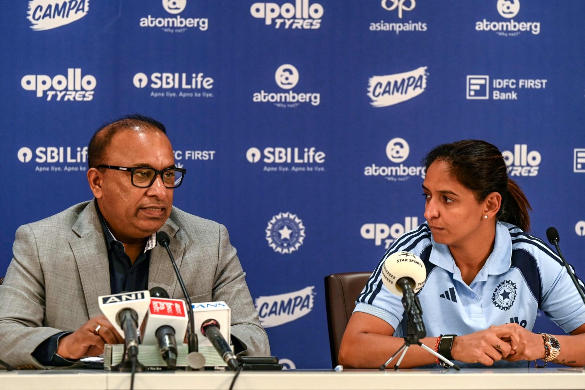 Indian women's cricket captain Harmanpreet Kaur (R) listens to BCCI Secretary Devajit Saikia announcing the squad for the upcoming ICC Women's T20 World Cup and tour of England, in Mumbai on May 2, 2026. (Photo by Indranil MUKHERJEE / AFP)
