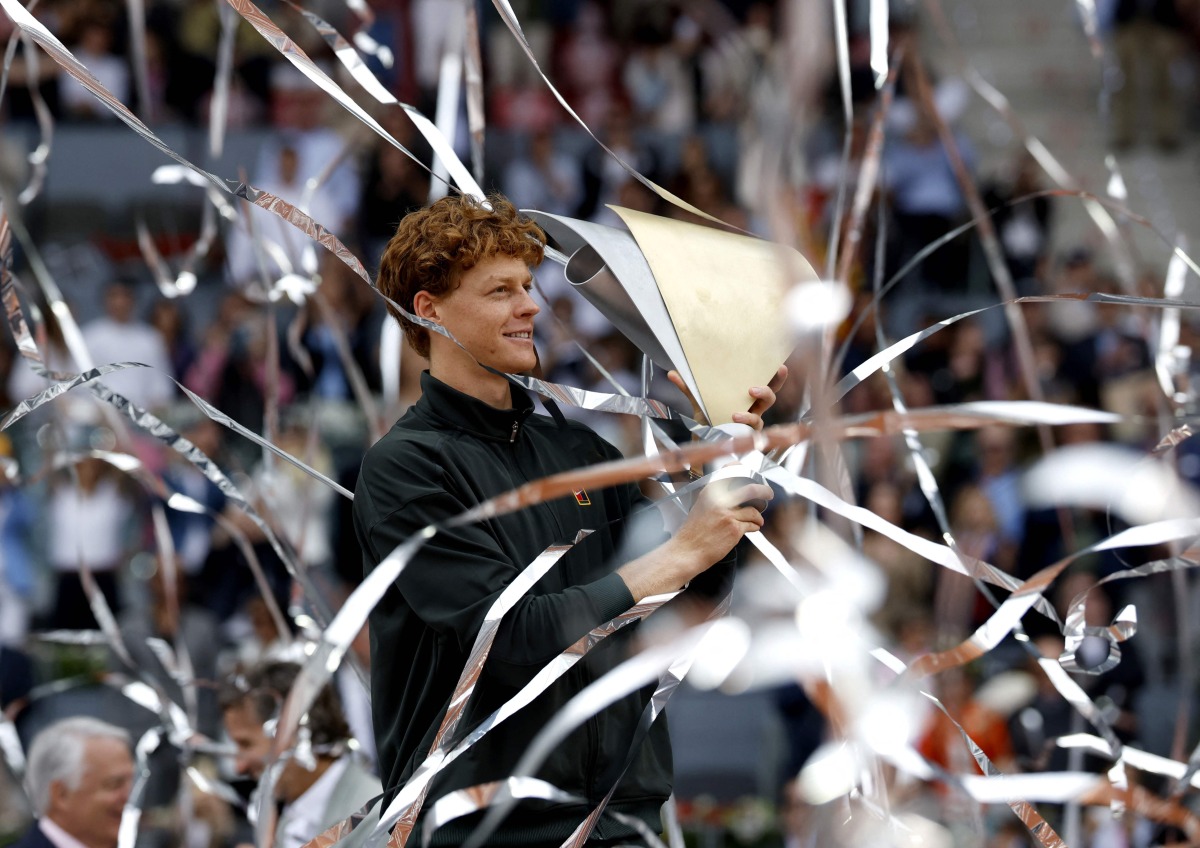 Italy's Jannik Sinner celebrates with his trophy after winning the 2026 ATP Tour Madrid Open tennis tournament final singles match against Germany's Alexander Zverev at the Caja Magica in Madrid, on May 3, 2026. (Photo by Oscar DEL POZO / AFP)
