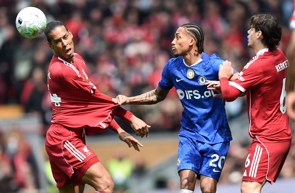 Chelsea's Brazilian striker #20 Joao Pedro pulls on the shirt of Liverpool's Dutch defender #04 Virgil van Dijk during the English Premier League football match between Liverpool and Chelsea at Anfield in Liverpool, north west England on May 9, 2026. (Photo by PETER POWELL / AFP)