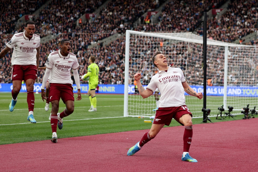 Arsenal's Belgian midfielder Leandro Trossard celebrates scoring the team's first goal during the English Premier League football match between West Ham United and Arsenal at the London Stadium, in east London on May 10, 2026. (Photo by Adrian Dennis / AFP) /