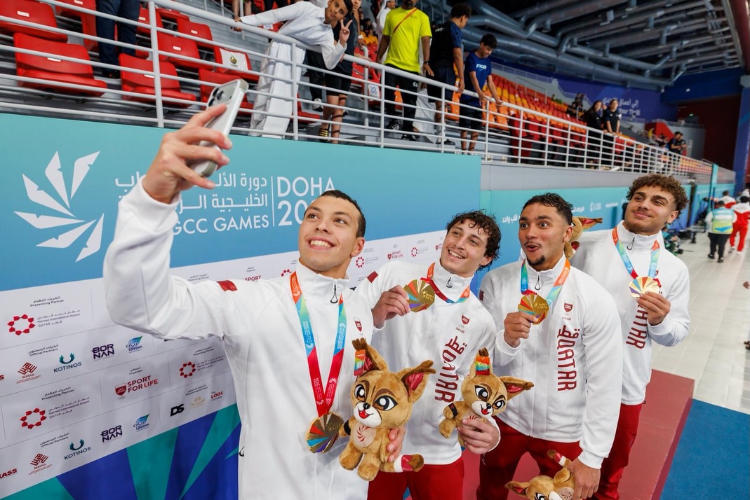 Members of Qatar's men's 400m freestyle relay team celebrate with a selfie after winning the gold medal.
