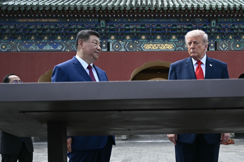 China's President Xi Jinping (C) and US President Donald Trump (R) visit the Temple of Heaven in Beijing on May 14, 2026. (Photo by Brendan Smialowski / Pool / AFP)