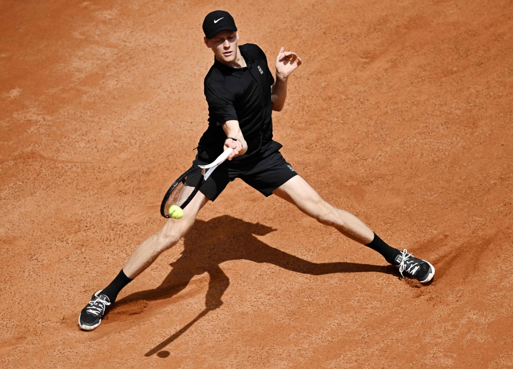 Italy's Jannik Sinner hits a return to Russia's Andrey Rublev during the ATP Rome Open tennis tournament at Foro Italico in Rome (Photo by Tiziana FabiI / AFP)