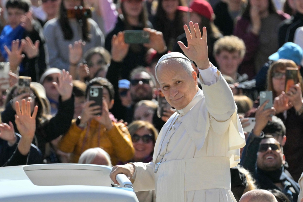 Pope Leo XIV waves to the crowd during the weekly general audience at St Peter's Square in The Vatican on April 8, 2026. Photo by Tiziana FABI / AFP