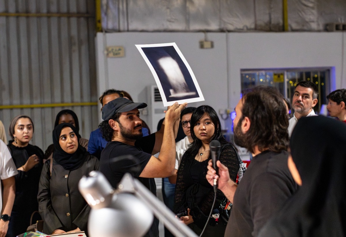 Habeeb Abu-Futtaim (holding the image) and Yousef Bahzad (with the mic) are previewing the artwork. Pic: Maria Ovsyannikova