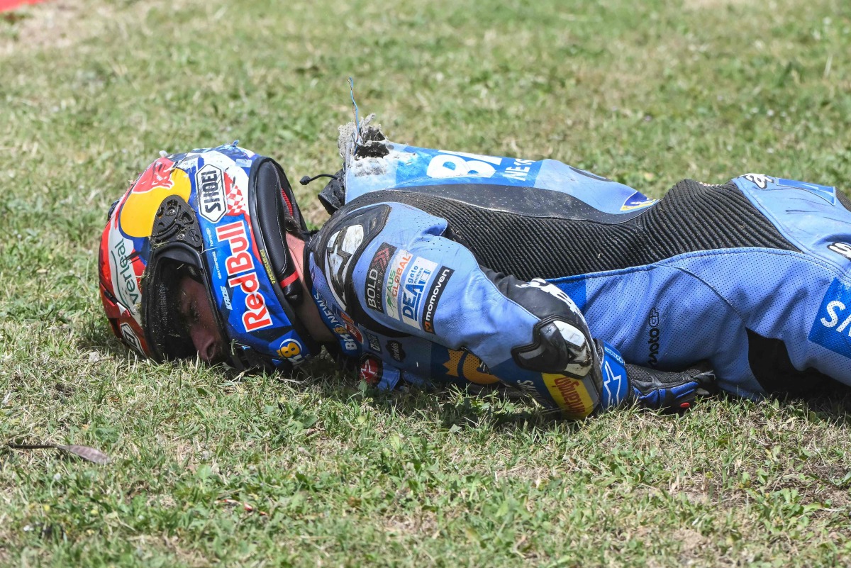 Team Gresini Racing MotoGP's Alex Marquez lies on the side of the track after crashing at high speed during the 2026 Catalunya Moto GP Grand Prix at the Catalunya racetrack in Montmelo, near Barcelona, on May 17, 2026. (Photo by JOSE JORDAN / AFP)