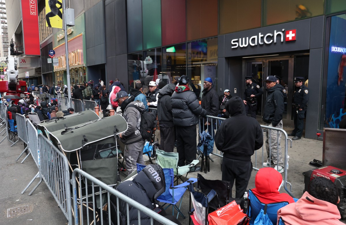 This photo taken on May 15, 2026, shows people camping out in line outside of the Swatch store in Times Square in New York, ahead of the May 16 release of the Audemars Piguet x Swatch Royal Pop watch. Photo by Timothy A. Clary / AFP
