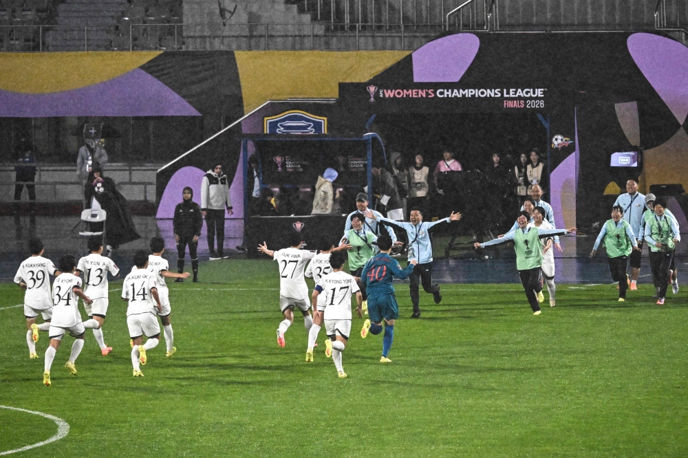 North Korea's Naegohyang Women's FC players celebrate after beating South Korea's Suwon FC Women in Suwon on May 20, 2026. (Photo by Pedro Pardo / AFP)
 