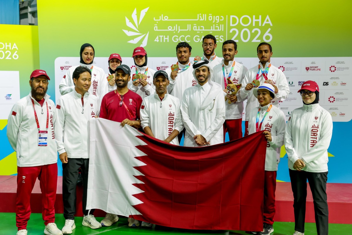 Qatar's medal-winning archers and officials pose for a photo.