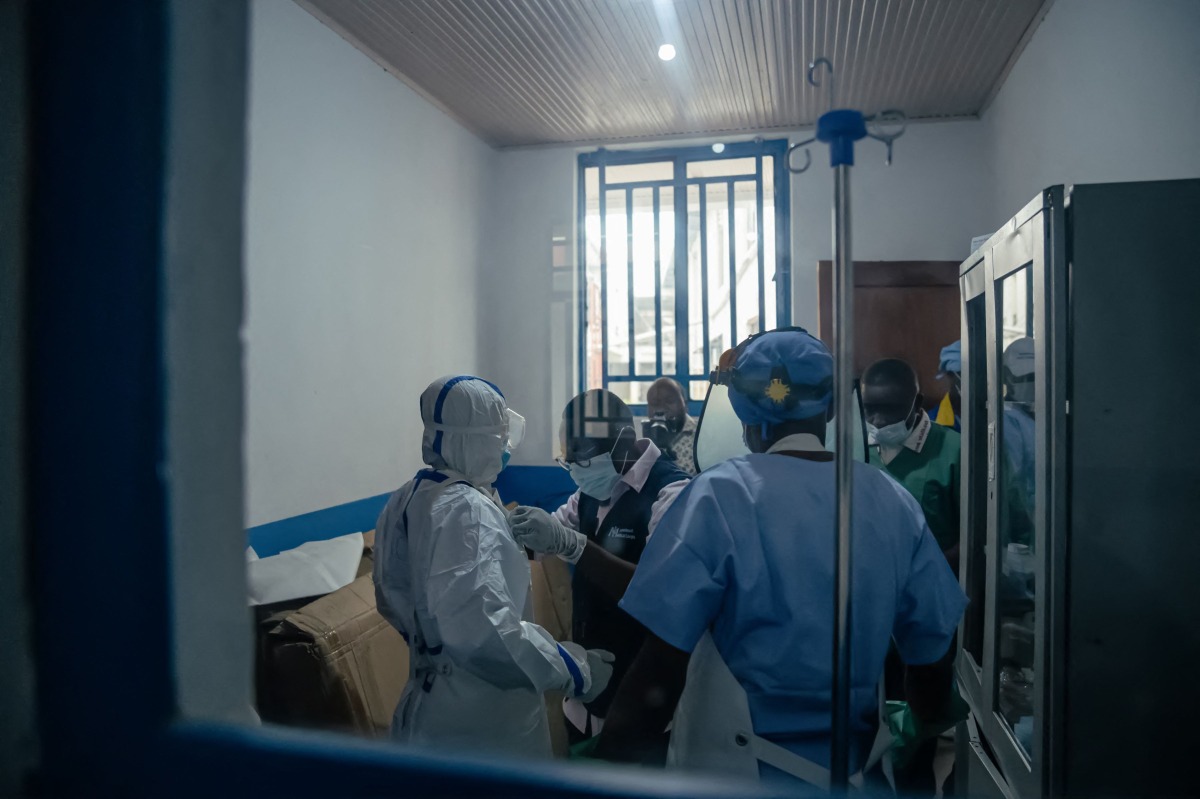 Dr Abdou Sebushishe (2nd L) Senior Health Advisor at International Medical Corps, guides and shows CBCA Virunga doctors how to properly put on single-use personal protective equipment provided by International Medical Corps, as part of support for Ebola virus disease prevention measures in Goma, on May 21, 2026. (Photo by Jospin Mwisha / AFP)