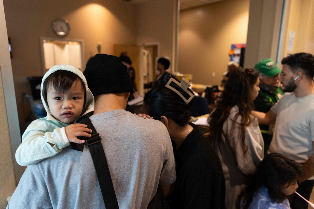 Evacuees check-in at a shelter after a chemical leak from a large storage tank threatened residents in Garden Grove, California on May 22, 2026. (Photo by Blake Fagan / AFP)
