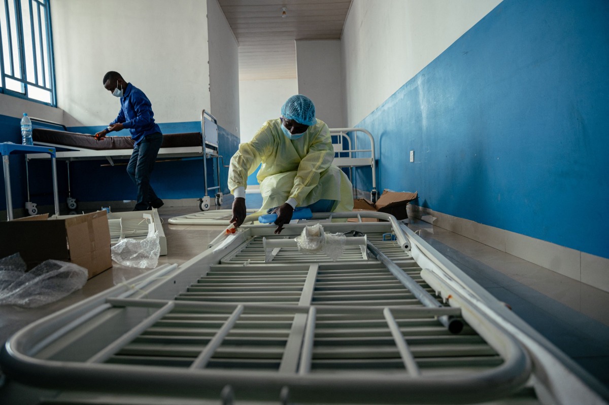 Technicians install beds and other equipment inside the isolation area for suspected cases at CBCA Virunga Hospital during rehabilitation work aimed at preparing the facility to receive potential Ebola cases, on May 22, 2026. (Photo by Jospin Mwisha / AFP)
