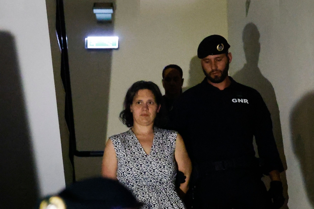 Frenchwoman Marine Rousseau (L) leaves the Setubal courthouse, suspected of abandoning two children, in Setubal, Portugal, on May 23, 2026. (Photo by Filipe Amorim / AFP)