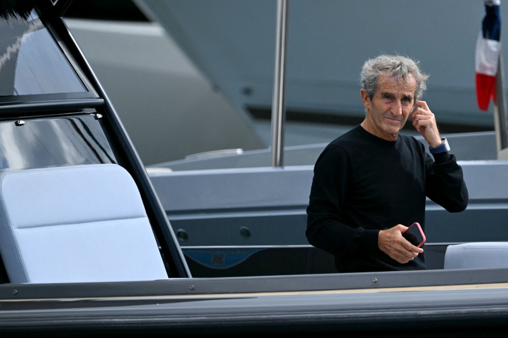 :(FILES) French former driver Alain Prost arrives by boat in the paddock of the Circuit de Monaco before the third practice session of the Formula One Monaco Grand Prix on May 25 2024, on the eve of the race. (Photo by NICOLAS TUCAT / AFP)