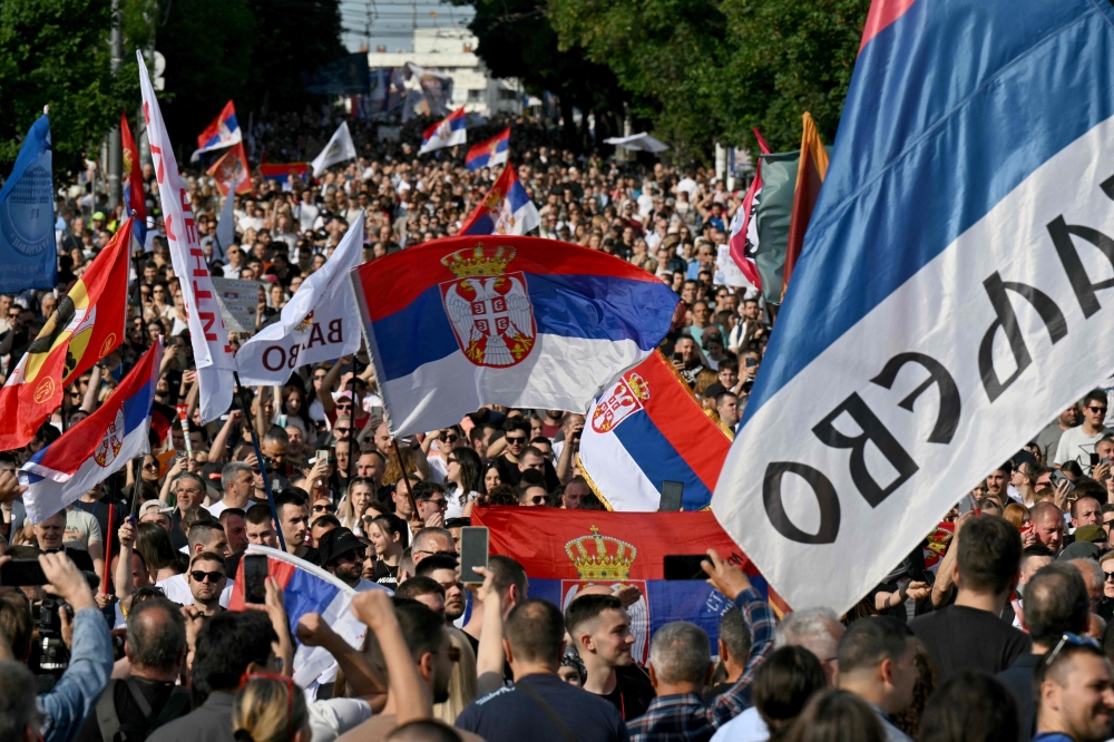 People march during an anti-government protest decrying corruption and calling for early elections following the collapse of a railway station canopy in Novi Sad that killed 16 in November 2024, in central Belgrade on May 23, 2026. (Photo by Andrej Isakovic / AFP)
 