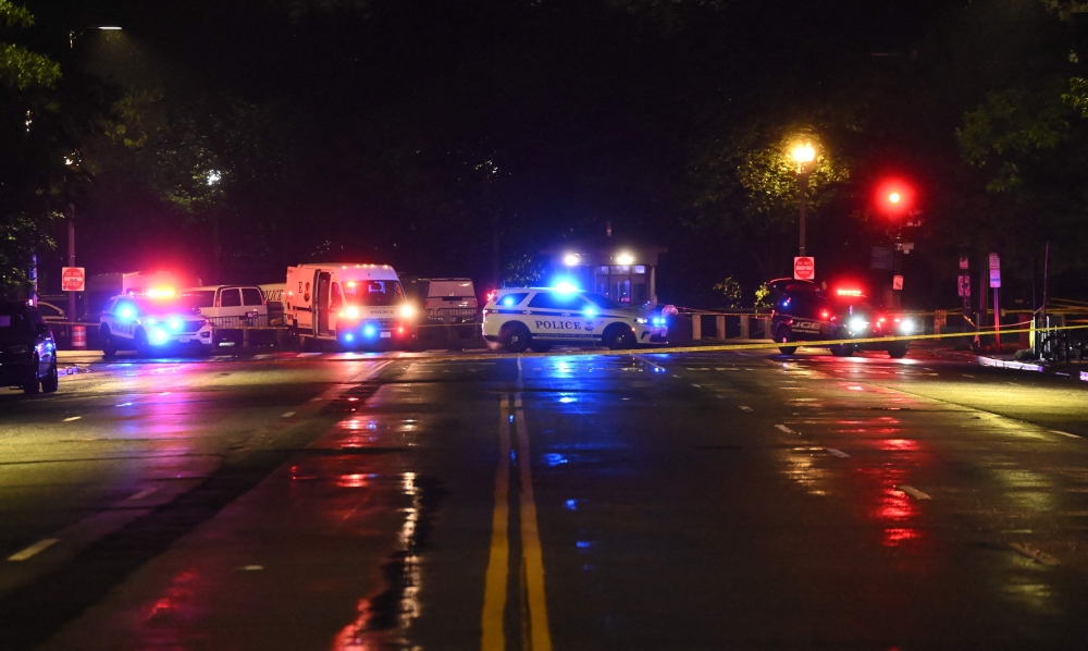 Police vehicles and tape blocks off a crime scene near the White House after a gunman opened fire in Washington, DC, on May 23, 2026. (Photo by Alex Wroblewski / AFP)