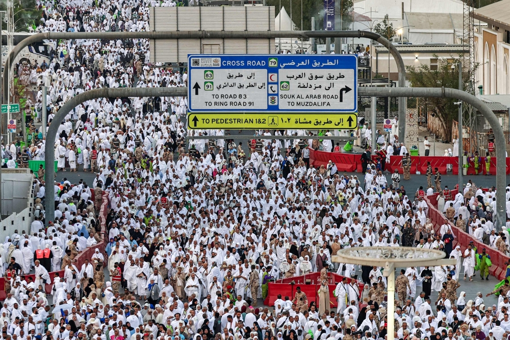 Muslim pilgrims pray near Saudi Arabia's Mount Arafat during the climax of the Hajj pilgrimage early on May 26, 2026.  (Photo by Zain Jaafar / AFP)