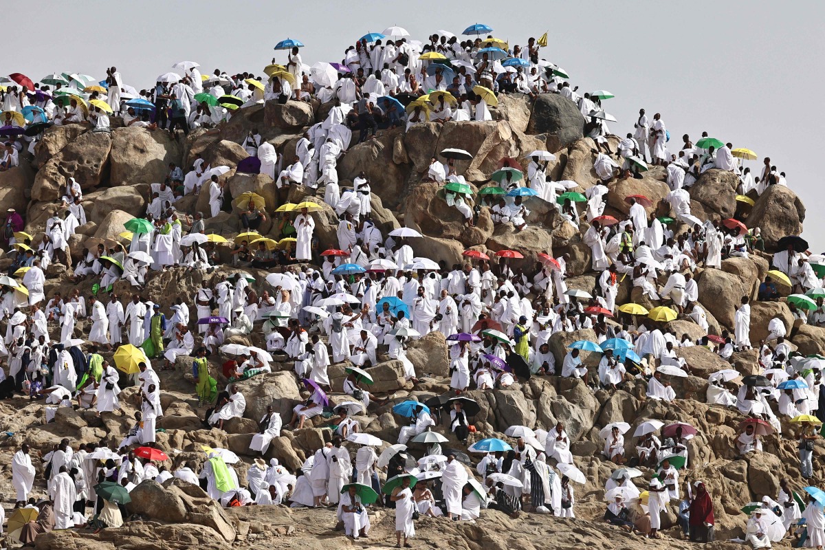 Muslim pilgrims pray on  Mount Arafat, also known as Jabal al-Rahma or Mount of Mercy, in Makkah, Saudi Arabia, on May 26, 2026. (Photo by Zain JAAFAR / AFP)