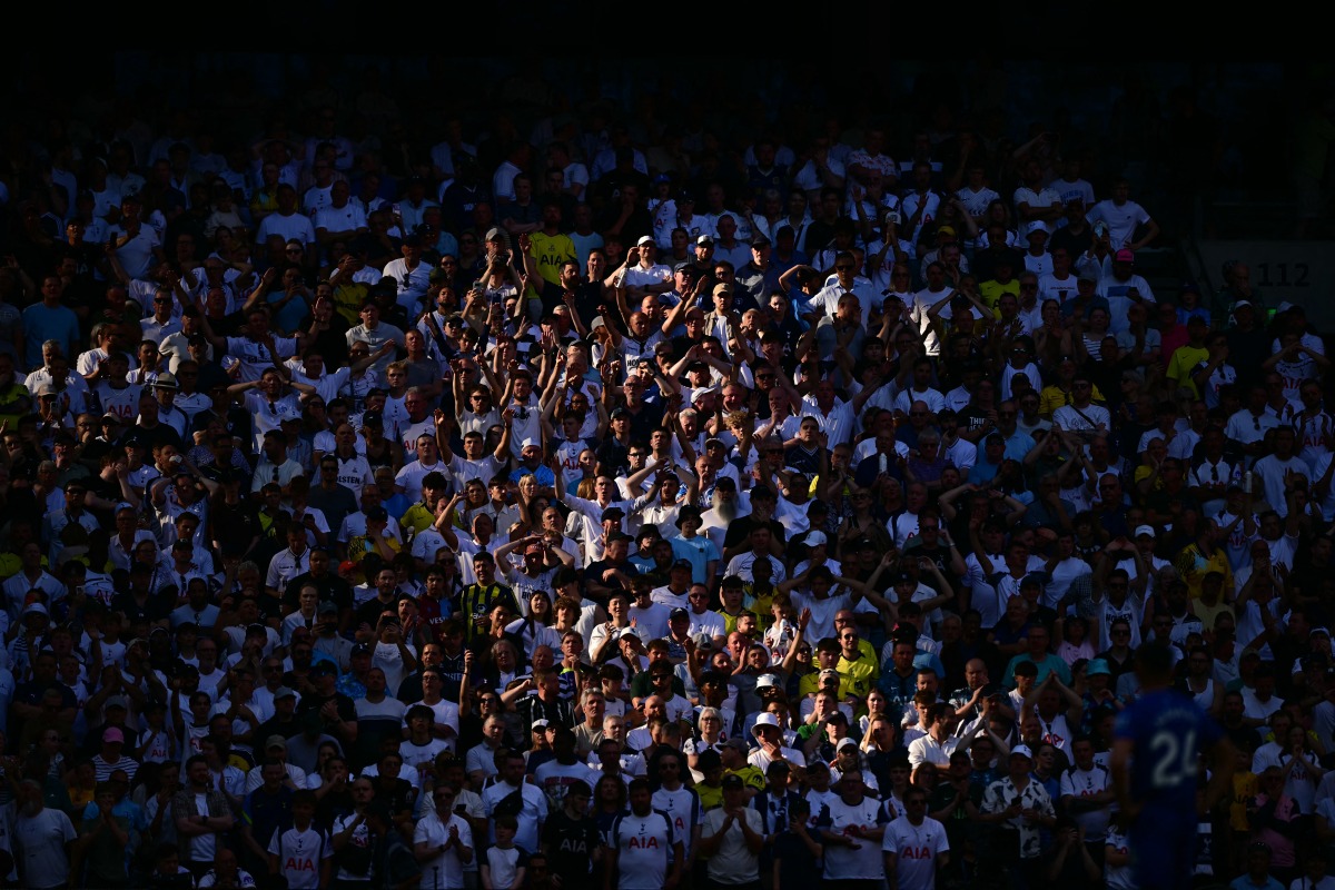 Spurs fans watch in the sunshine during the English Premier League football match between Tottenham Hotspur and Everton at the Tottenham Hotspur Stadium in London, on May 24, 2026. Photo by Ben STANSALL / AFP