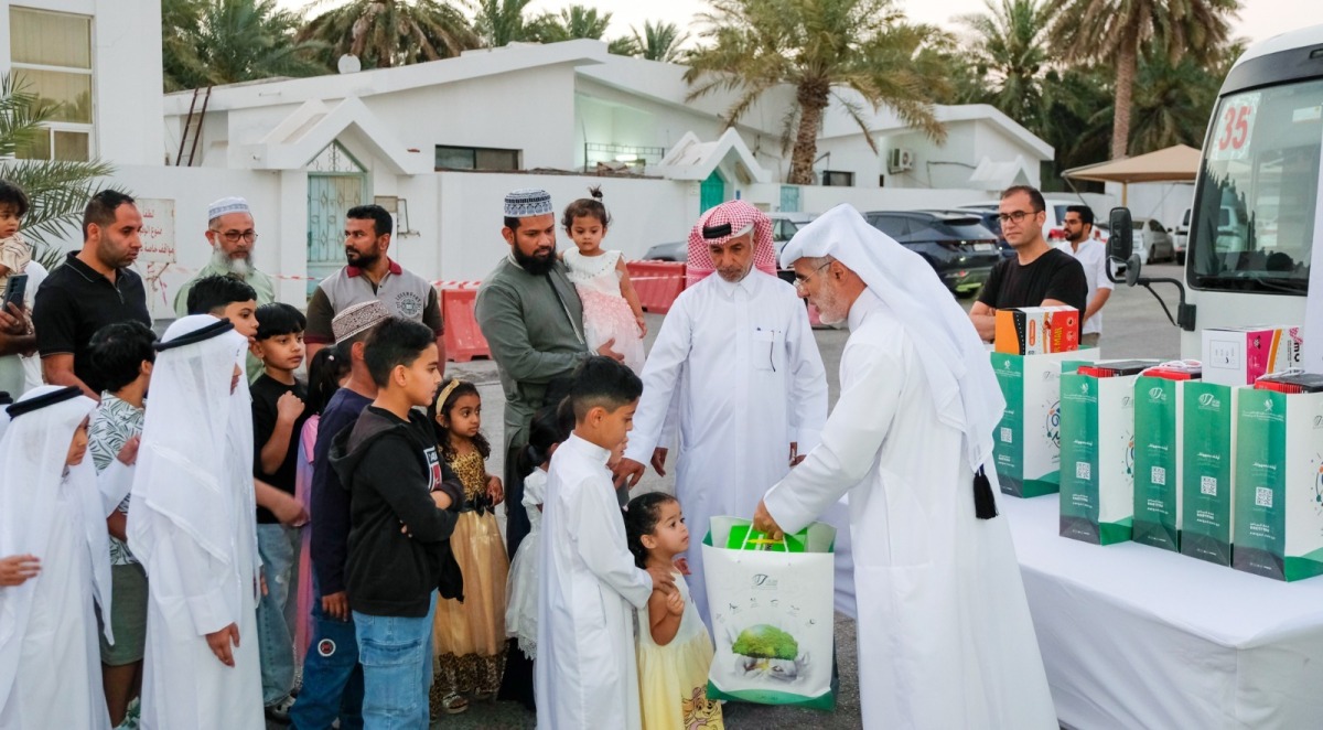 Ministry of Awqaf and Islamic Affairs representatives distributing gifts to children as part of the ‘Joy of Eid’ initiative.