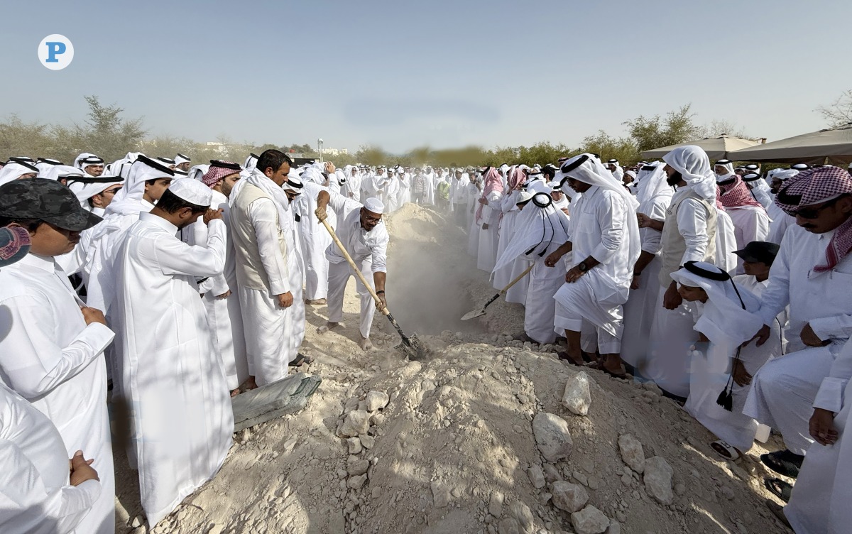 People take part in the burial of Abdullah bin Hamad Al Attiyah.