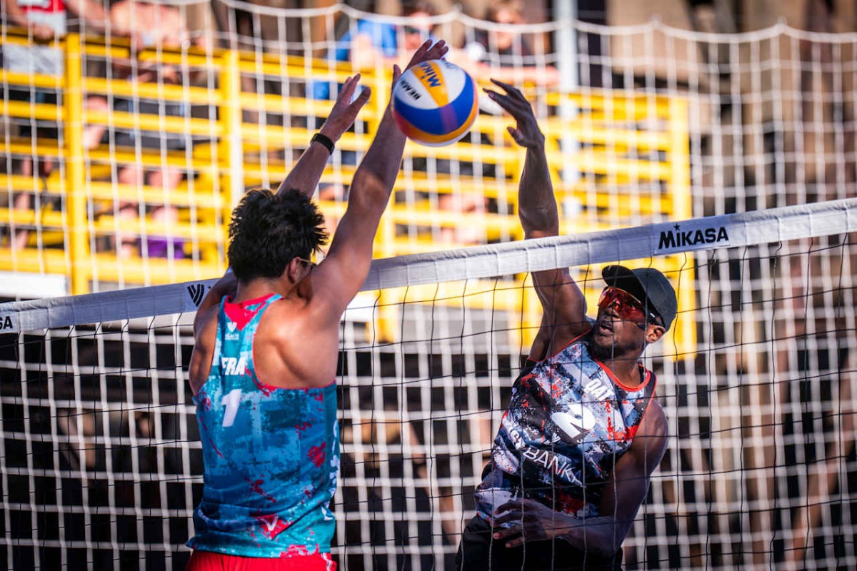 Qatar's Ahmed Tijan (right) shoots to score a point.