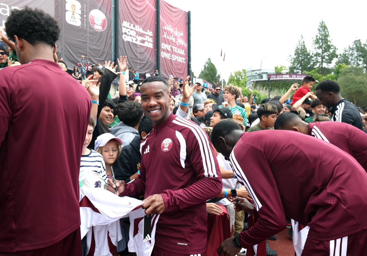 Qatar midfielder Assim Madibo signs autographs for young fans in Santa Barbara, California, on Friday. 