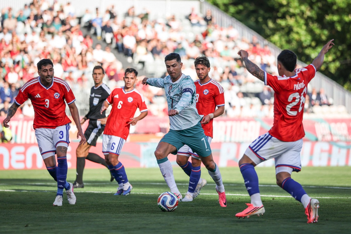 Portugal's Cristiano Ronaldo (centre) controls the ball.