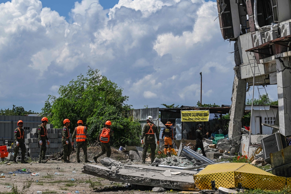 Responders conduct search and rescue operations at the site of a collapsed building after a 7.8 magnitude earthquake in General Santos City on June 9, 2026. (Photo by Jam STA ROSA / AFP)