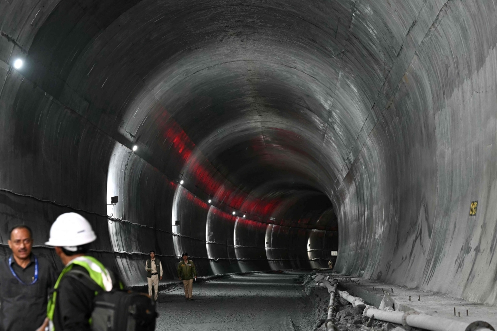 Indian police personnel stand guard at the Zojila tunnel, India's longest road tunnel project connecting Jammu and Kashmir state with the Ladakh region on June 9, 2026. (Photo by Tauseef Mustafa/ AFP)
