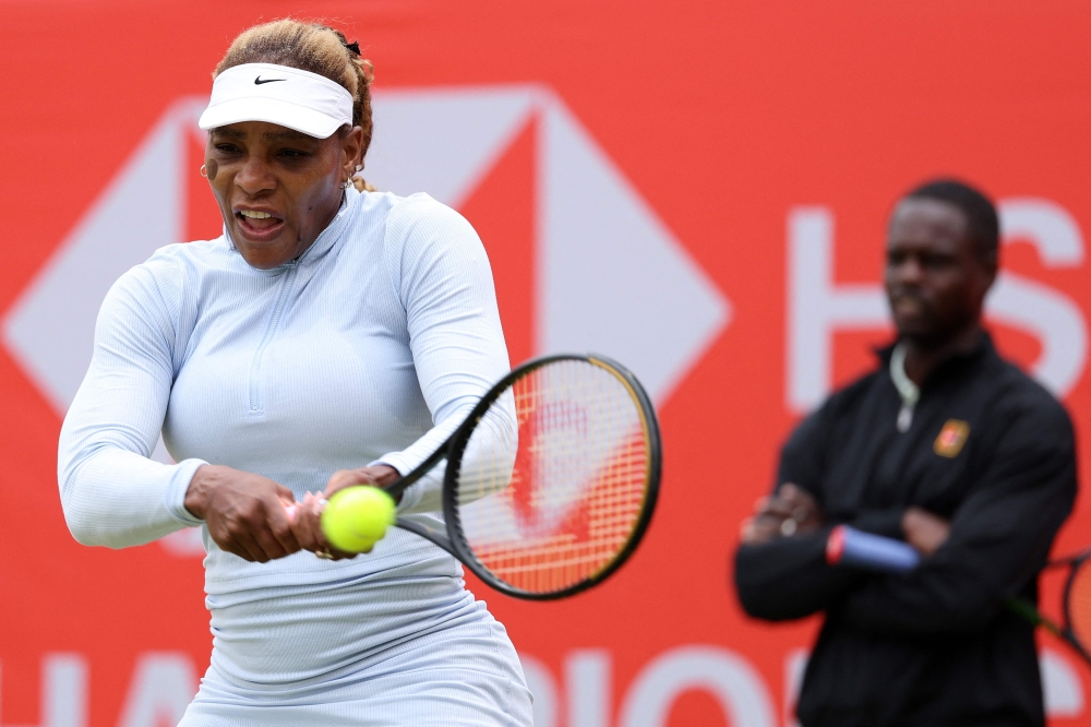US player Serena Williams hits a shot during a practice session, watched US coach Jarmere Jenkins, at the HSBC WTA tennis Championships at Queen's Club in west London on June 12, 2026.  (Photo by Adrian Dennis / AFP)