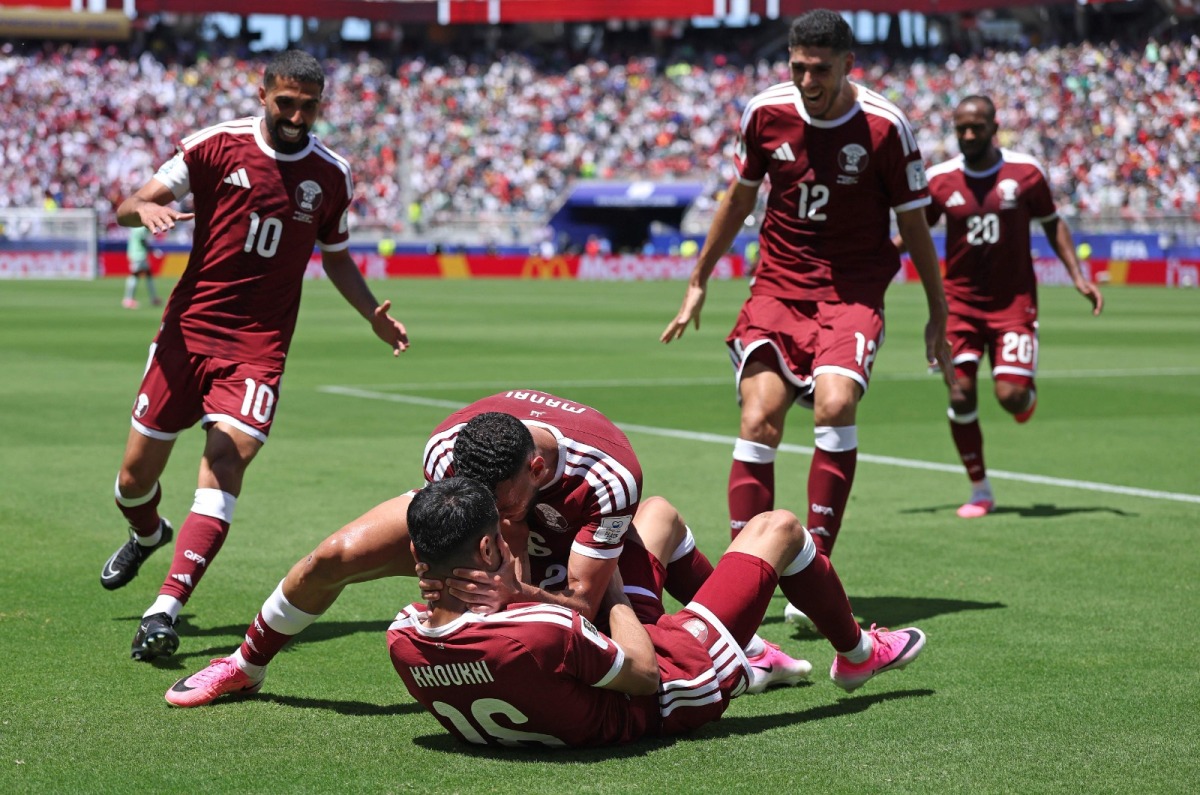 Boualem Khoukhi celebrates with teammates after scoring Qatar's first goal against Switzerland during the FIFA World Cup 2026 Group B match at San Francisco Bay Area Stadium on June 13, 2026 in Santa Clara, California.