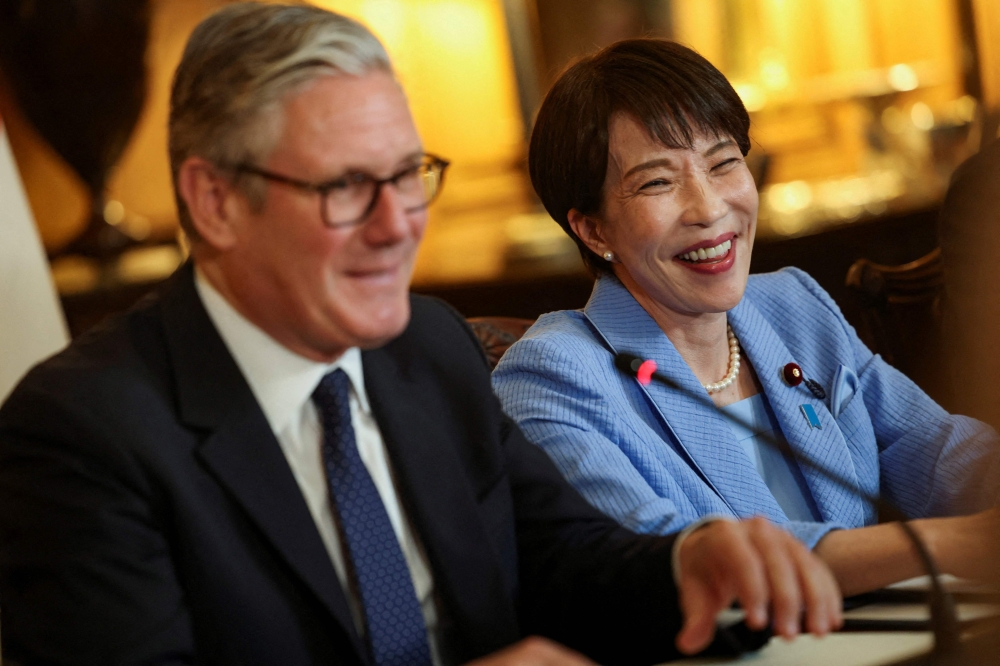 Britain's Prime Minister Keir Starmer (L) and Japan's Prime Minister Sanae Takaichi attend a business roundtable meeting at Downing Street in central London on June 14, 2026. (Photo by Toby Shepheard / POOL / AFP)