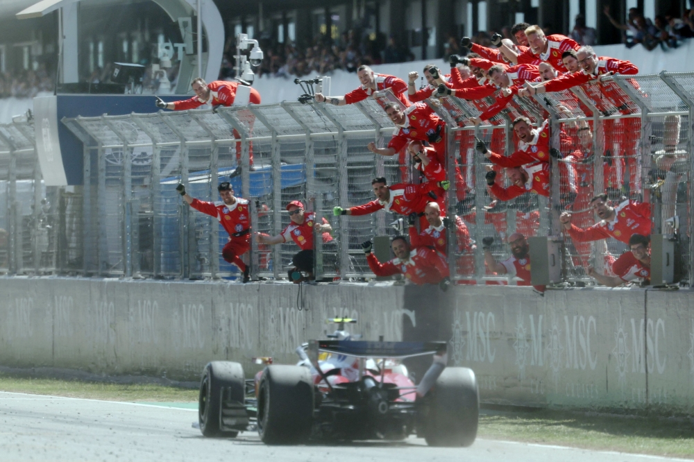 Ferrari team members celebrate Ferrari's British driver Lewis Hamilton's victory in the Catalonia Formula One Grand Prix at the Circuit de Catalunya in Montmelo, on the outskirts of Barcelona, on June 14, 2026. (Photo by Lluis GENE / AFP)
