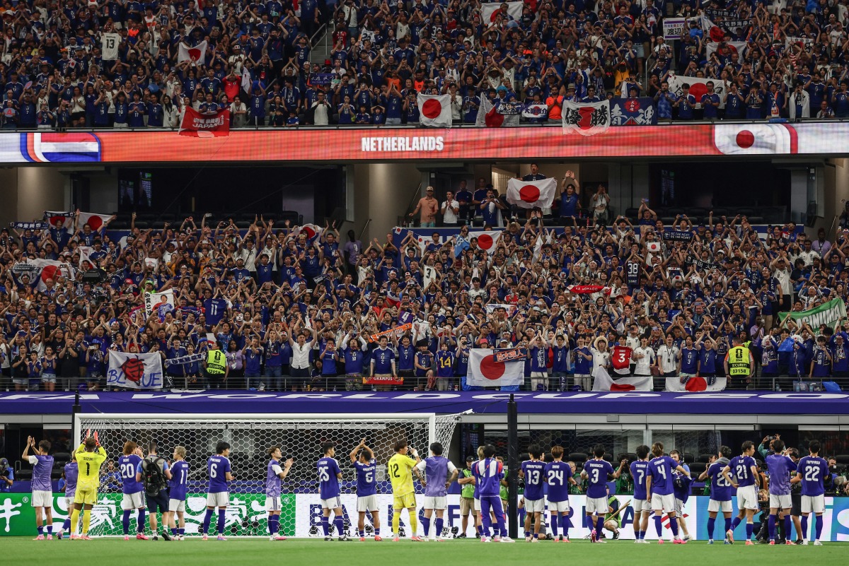 Japan's players reat with supporters after a draw in the 2026 World Cup Group F football match between the Netherlands and Japan at the Dallas Stadium in Arlington on June 14, 2026. (Photo by Aric Becker / AFP)
