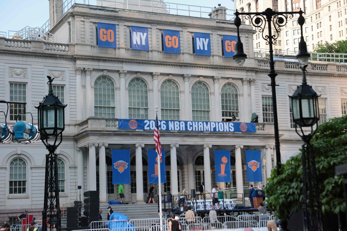 New York Knicks banners adorn the facade of City Hall ahead of the ticker tape victory parade on June 17, 2026 in New York City. Photo by Michael M. Santiago / GETTY IMAGES NORTH AMERICA / Getty Images via AFP