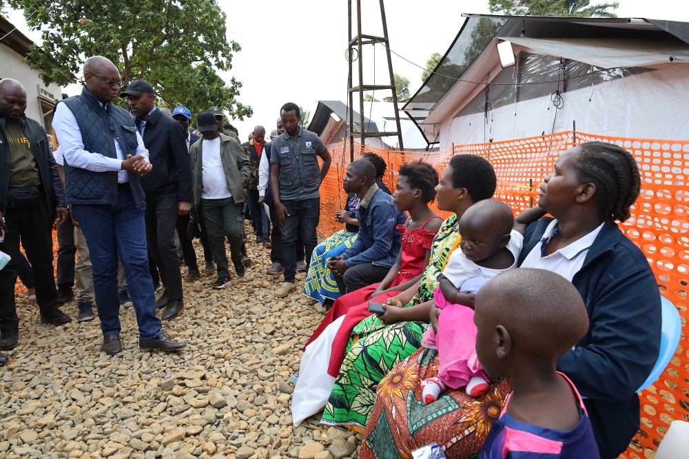 Health Minister of the Democratic Republic of the Congo Roger Kamba (2nd L) congratulates a recovered Ebola patient in Mongbwalu, Ituri province, the Democratic Republic of the Congo, June 20, 2026. (Xinhua)
 